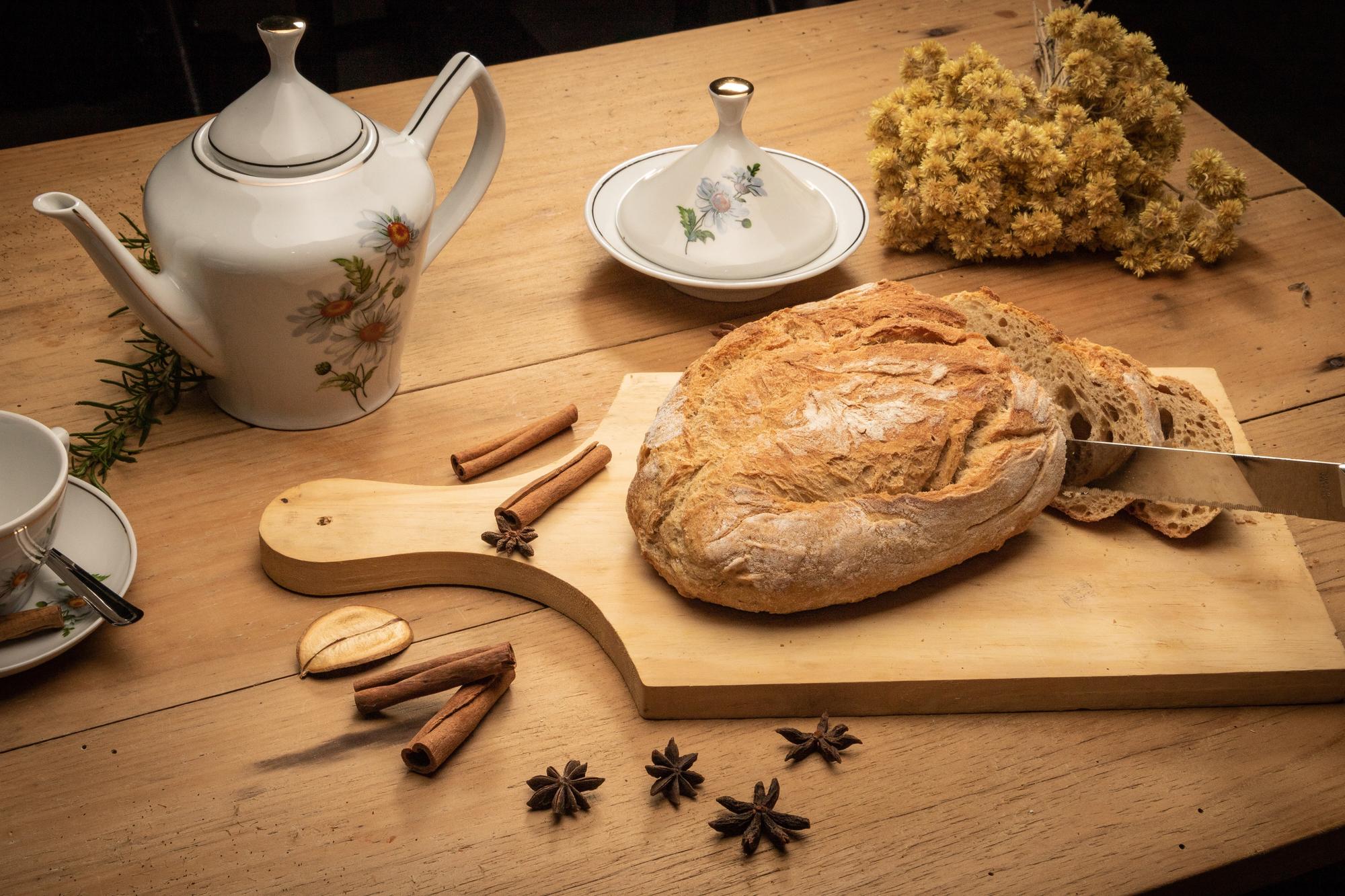 Wooden board with artisanal breads and herbs